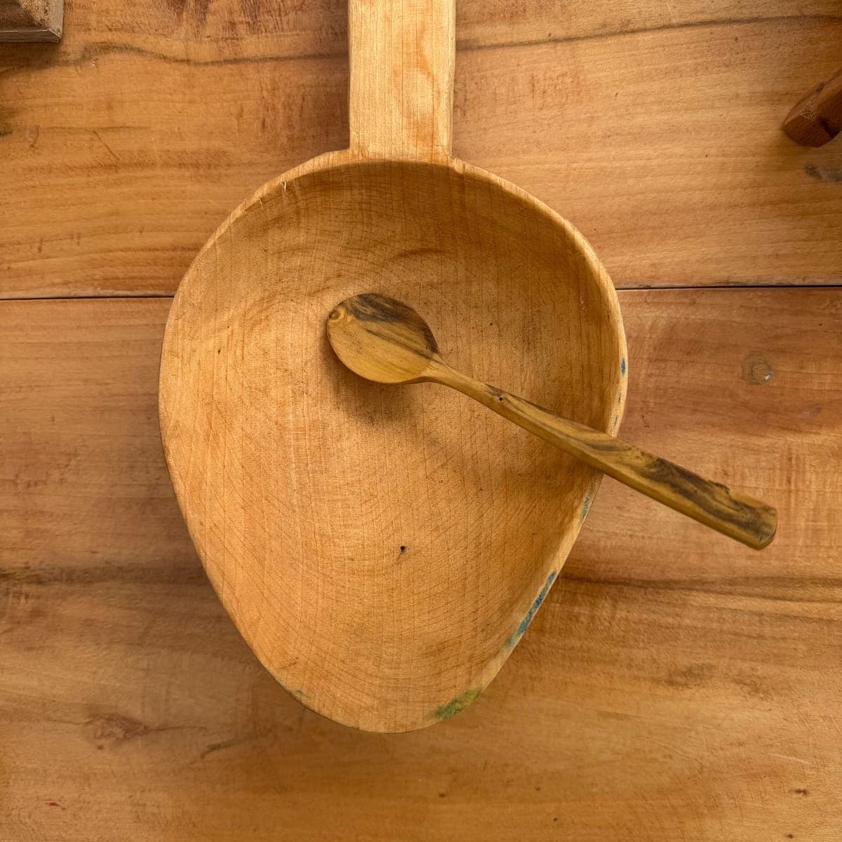 A hand-carved wooden scoop and spoon by an independent maker